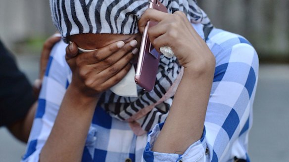 Yaz (no surname given) awaits news of her friend who was caught in the fire.