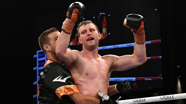 Hornet stings: Jeff Horn celebrates after successfully defending his WBO world welterweight champion title against UK boxer Gary Corcoran.