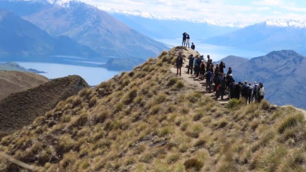 People queue to get photos at Roy's Peak, New Zealand.