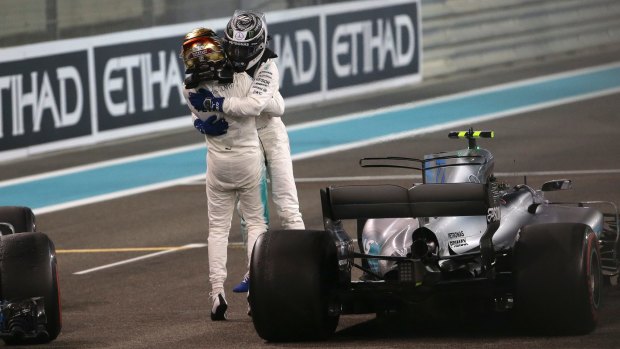 Mercedes drivers Valtteri Bottas and Lewis Hamilton embrace after finishing one-two in Abu Dhabi.