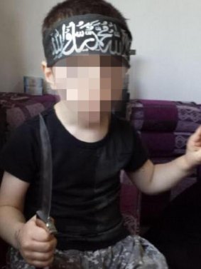 A photo of one of Khaled Sharrouf's sons holding a knife.  