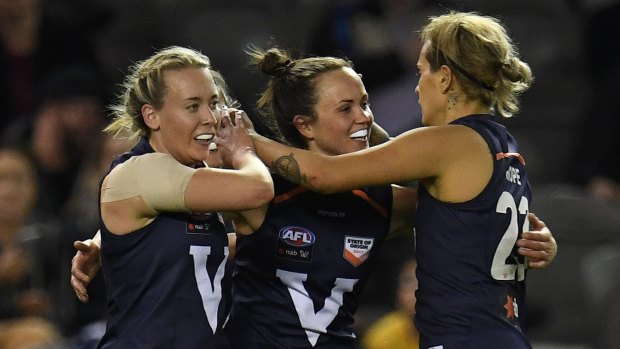 AFLW in good state: Lauren Arnell, Daisy Pearce and Moana Hope celebrate a Big V goal.