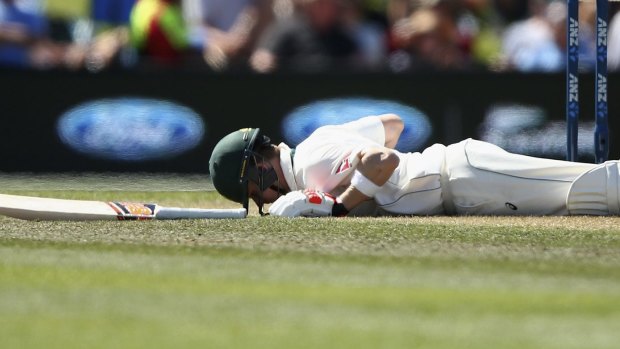 Worrying scenes: Steve Smith lies on the ground after he was hit in the head by a delivery from Neil Wagner on day two.