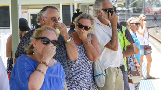 Local residents try to block the smell emitting while waiting for a train at Mulgrove Station 