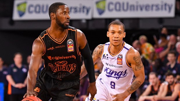 Weighing options: Scoochie Smith of the Taipans eyes support.