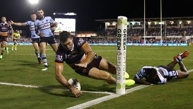 Off to a flyer: Corey Oates crosses in the corner in Brisbane's win over Cronulla.