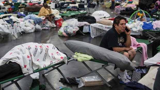 People displaced by flooding rest at a temporary shelter at the George R. Brown Convention Center in Houston.