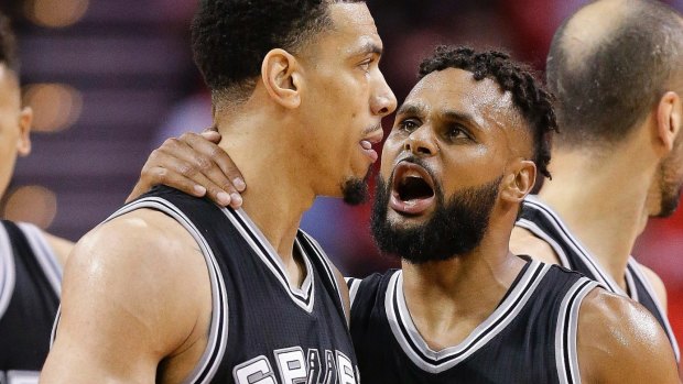 Patty Mills talks with guard Danny Green as Spurs ousted the Rockets from the NBA conference semi-finals.