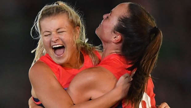 Sarah Jolly and Daisy Pearce celebrate a goal.