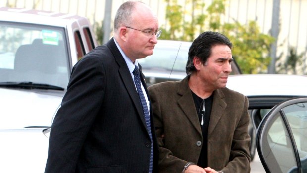 Lucky Gattellari, right, pictured in October 2010, when he was arrested for questioning in relation to the murder of Michael McGurk.