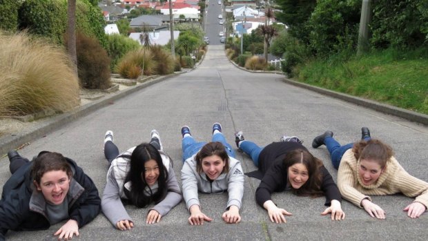 Students from Melbourne, Australia, pose for a photograph on Baldwin St, which is still the world's steepest street.