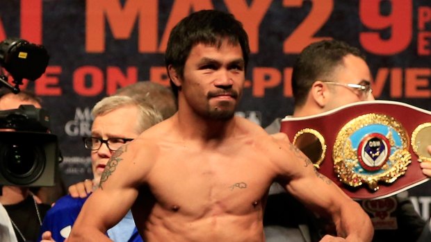 Manny Pacquiao poses on the scale.