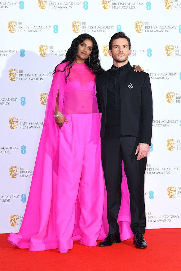 Simone Ashley and Jonathan Bailey. Ashley wears Valentino.