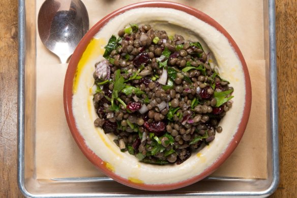 Hummus loaded with lentil and grain salad.
