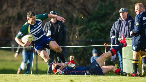 Gareth Watts tries to evade a tackle during Uni-Norths' match against Easts.