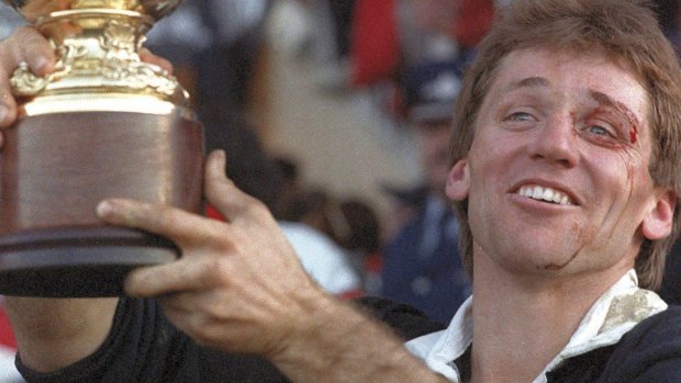 Then-All Black captain David Kirk holds up the William Webb Ellis trophy after New Zealand's victory in the Rugby World Cup final over France at Auckland's Eden Park in 1987.
