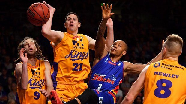 Congested: Darcy Harding and Jeromie Hill of the Kings compete for the ball with Jerome Randle.