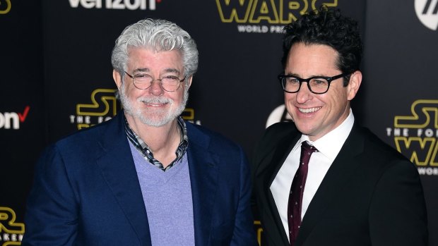 George Lucas (left) and writer/director J.J. Abrams attend the premiere of Walt Disney Pictures and Lucasfilm's <i>Star Wars: The Force Awakens</i>.