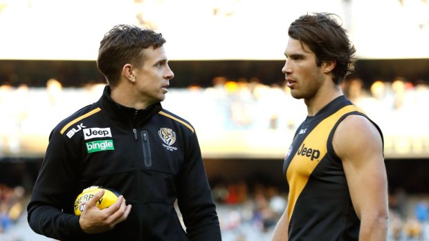 An injured Brett Deledio chats to Alex Rance during a break at the MCG.