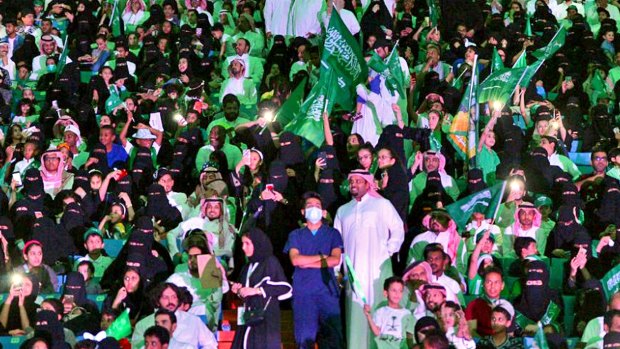 Saudi men and women attend national day ceremonies at the King Fahd stadium in Riyadh. Women will be allowed to attend select football matches as the kingdom's latest step toward easing rules on gender segregation - but they will only be allowed to sit in the so-called family section.