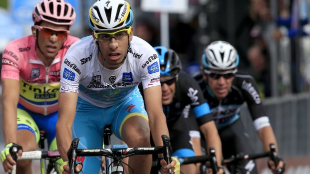Still together: Race leaders Fabio Aru (C) with pink jersey holder Alberto Contador  and Richie Porte cross the finish line.