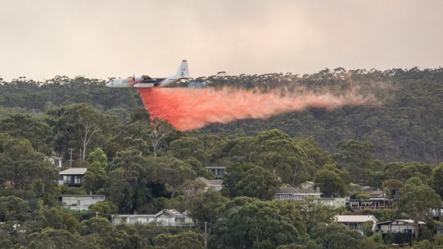 A waterbomber sprays fire retardent on bushland on the outskirts of Lorne on Christmas Day. 