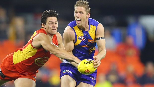 Scott Selwood of the Eagles runs the ball from Jesse Lonergan of the Suns .