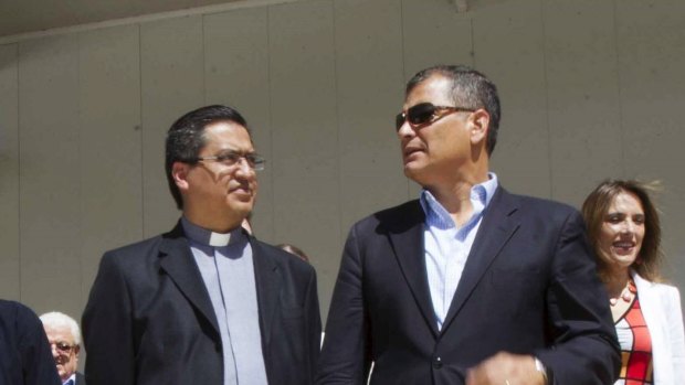 Ecuador's President Rafael Correa, right, talks to a priest as he visits the Bicentenario Park, where Pope Francis will hold a mass during his visit.