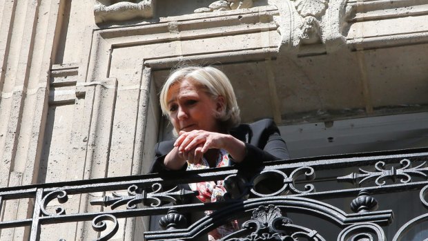 Marine Le Pen appears on the balcony of her campaign headquarters in Paris on Monday.