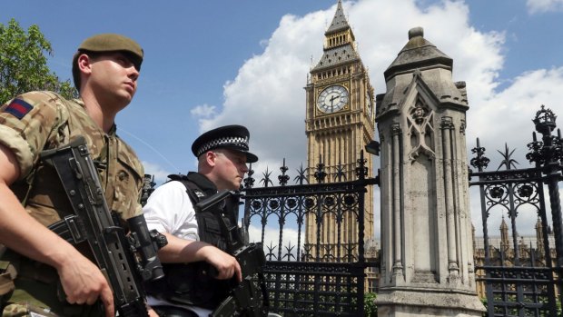 A member of the army joins police officers in Westminster after the Manchester bombing.