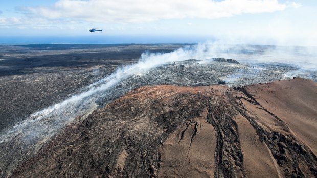 Helicopter tour flies over lava flow, Hawaii Island.