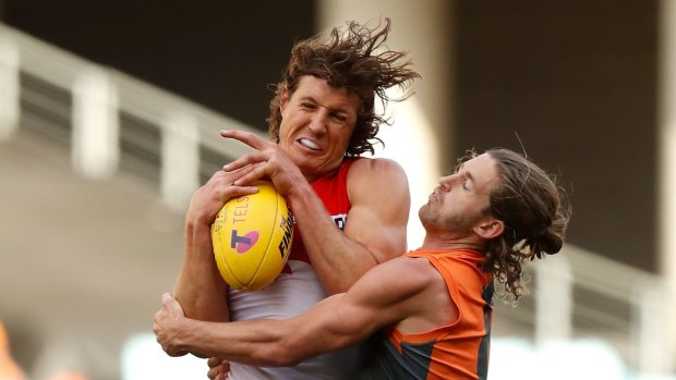 Casualty: Swans' Kurt Tippett was left with a broken jaw after being clattered by Callan Ward while contesting a ruck during the qualifying final.
