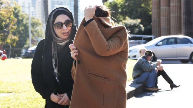 Mohammed Hamzy's wife Meltem Yarar (under the coat) with an unidentified woman outside court on Wednesday.