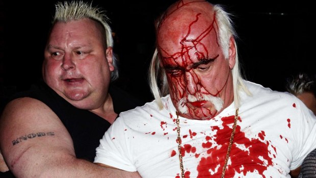 Hulk Hogan is escorted away by Brian Knobbs after an altercation with Rick Flair during a Sydney press conference for "Hulkamania – Let The Battle Begin" in 2009.