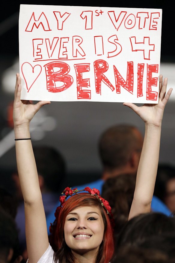 Lauren Esquivel displays a sign supporting Democratic presidential candidate Bernie Sanders in Miami on Tuesday.