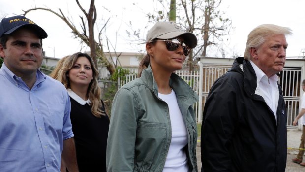 President Donald Trump and first lady Melania Trump take a walking tour with Puerto Rico Governor Ricardo Rossello, left.