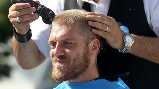 Melbourne City's Luke Brattan having his hair cut for the World's Greatest Shave charity at AAMI Park on Wednesday.