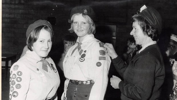 Jenny James receives her Queen's Guide badge in 1975 from Woden Valley Commissioner for Guides Shirley McLennan.