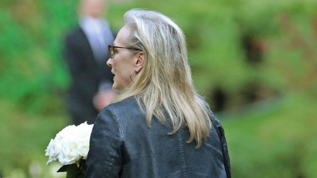 Actress Meryl Streep arrives with flowers.