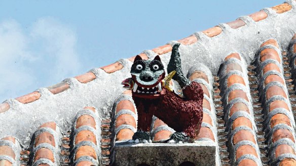 A shisa statue, to protect the household, adorns a roof on Taketomi, one of the Okinawa chain of islands.