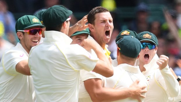 Big moment: Josh Hazlewood celebrates taking the wicket of Alastair Cook.