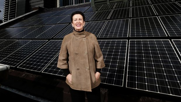 Clover Moore, Mayor of Sydney,  on the roof of Sydney Town Hall with solar panels. 