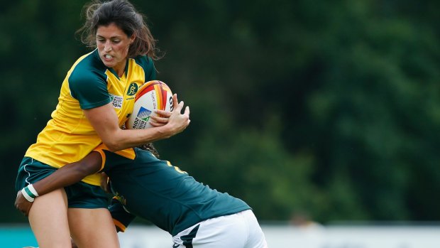 Natasha Haines of Australia is tackled by Lorinda Brown of South Africa.