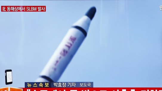 A South Korean man watches TV news footage of a missile launch conducted by North Korea in April.