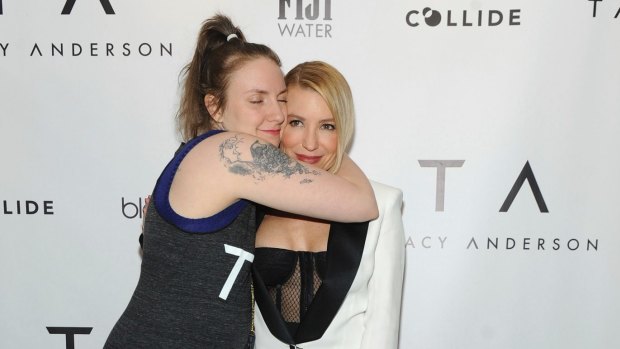 Lena Dunham gives a hug to Tracy Anderson at the opening party of the Tracy Anderson 59th Street studio.