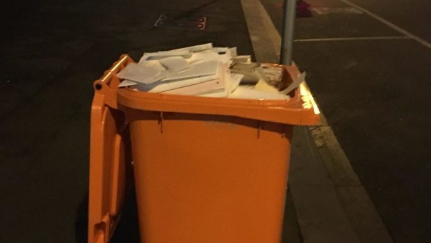 The unlocked bin fllled with confidential documents left on the street in Melbourne's legal precinct.