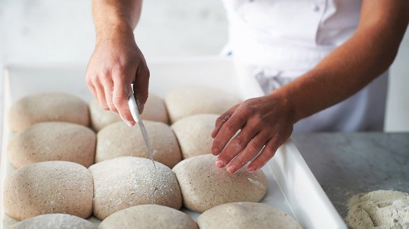 Shaping the base step 2: Use the bench scraper to separate the dough ball from its neighbours.