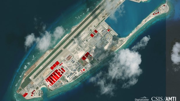 A satellite image of Fiery Cross Reef in Spratly island chain in the South China Sea. The red portions depict infrastructure built in 2017.