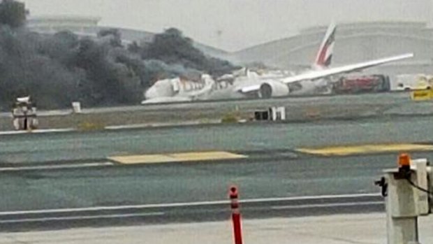 An Emirates plane caught fire after making a crash-landing at Dubai airport.