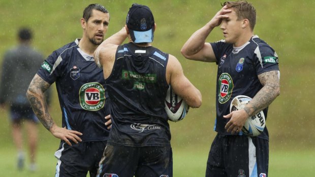 Feeling the heat: Blues halves Mitchell Pearce (left) and Trent Hodkinson (right) talk things over at training in Coffs Harbour with Robbie Farah.